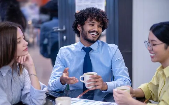 Colleagues talking an idea through over coffee