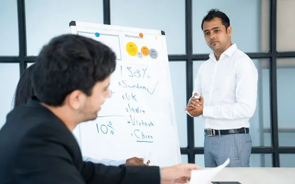 A trainer at a whiteboard during a session