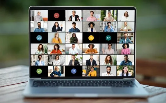 A laptop showing a video call with a grid of learners